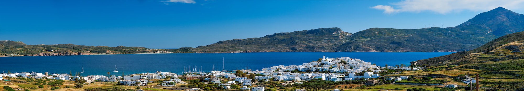 View of Plaka village with traditional Greek church. Milos island, Greece